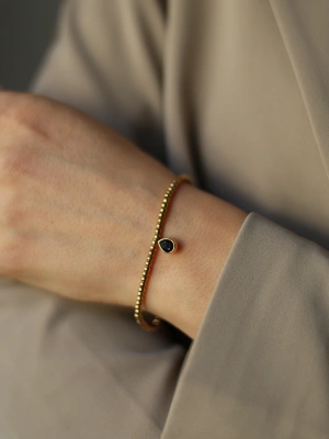 Bransoleta na gumce złote kulki z czarną kroplą